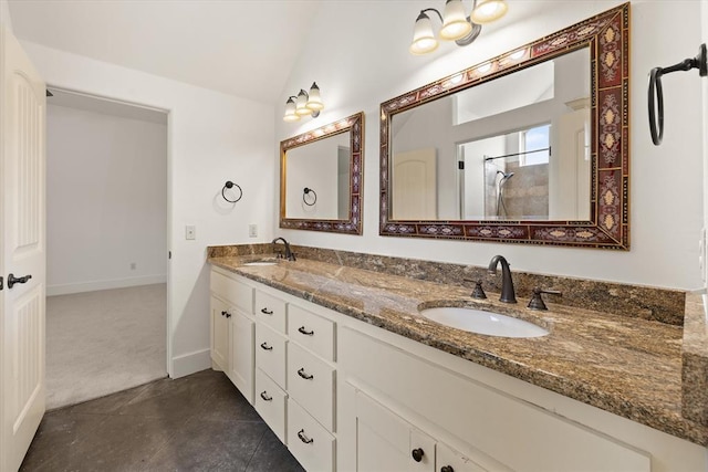 bathroom with vaulted ceiling, a sink, double vanity, and tiled shower