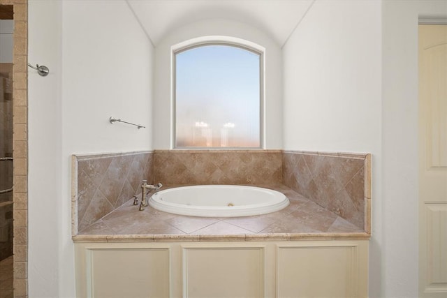 full bathroom with a whirlpool tub