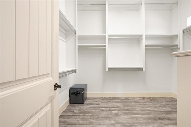 spacious closet with wood finished floors