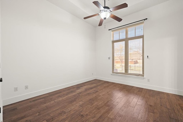empty room with lofted ceiling, baseboards, a ceiling fan, and dark wood-style floors