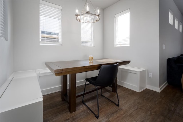dining room with an inviting chandelier, wood finished floors, and baseboards