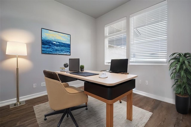 office area featuring baseboards, wood finished floors, and plenty of natural light