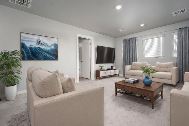 living room with visible vents, recessed lighting, and light colored carpet