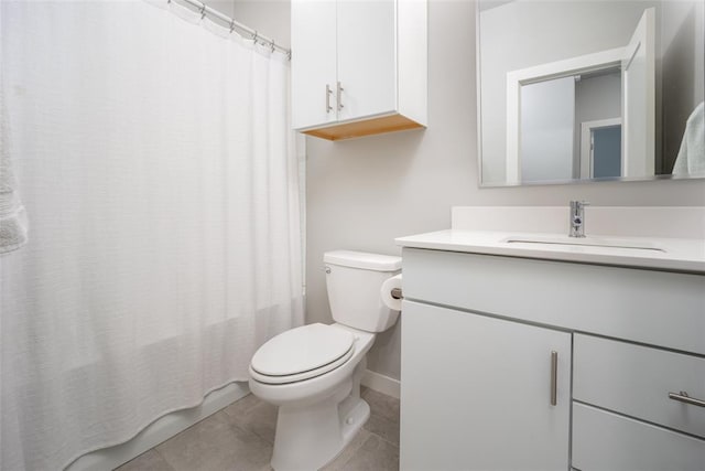 full bath with tile patterned floors, baseboards, vanity, and toilet