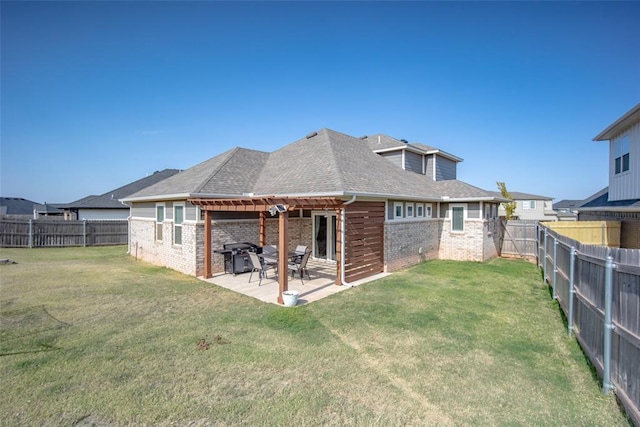 rear view of house featuring a fenced backyard, a pergola, brick siding, and a lawn