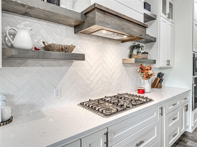 kitchen featuring white cabinetry, tasteful backsplash, open shelves, glass insert cabinets, and stainless steel appliances