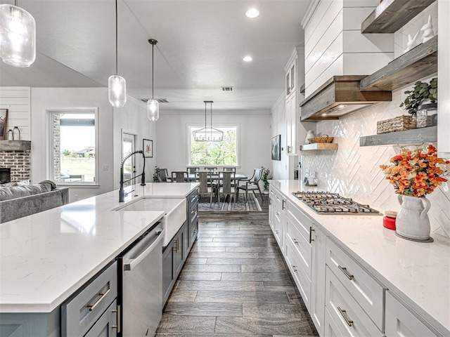 kitchen with recessed lighting, a sink, decorative backsplash, open shelves, and appliances with stainless steel finishes
