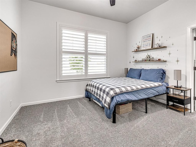 carpeted bedroom featuring baseboards and a ceiling fan