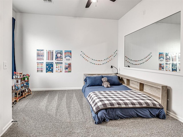 carpeted bedroom featuring a ceiling fan, visible vents, and baseboards