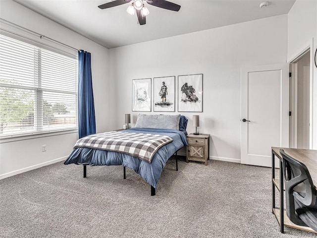 carpeted bedroom featuring a ceiling fan and baseboards