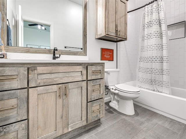 bathroom with a ceiling fan, shower / tub combo with curtain, toilet, and vanity