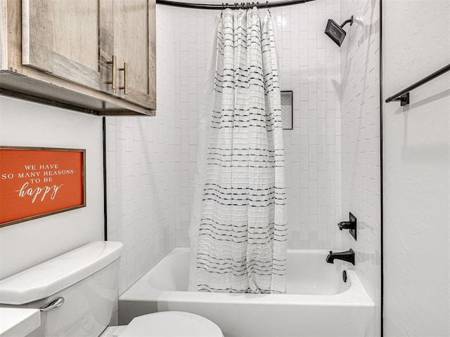 bathroom with shower / tub combo and toilet