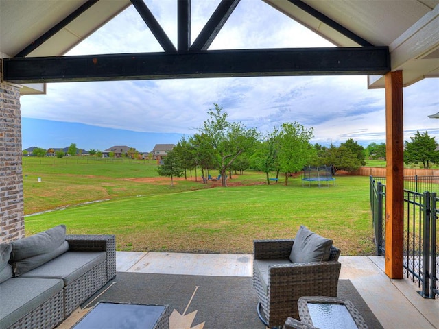view of patio / terrace featuring a trampoline and fence