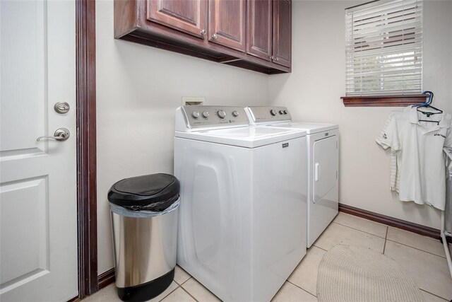 2400 Whiteoak Dr, Blanchard, OK 73010 - laundry area with washing machine and clothes dryer, baseboards, light tile patterned floors, and cabinet space