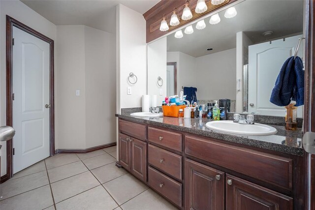 2400 Whiteoak Dr, Blanchard, OK 73010 - full bathroom featuring double vanity, tile patterned flooring, baseboards, and a sink