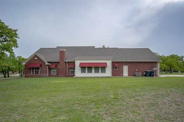 2400 Whiteoak Dr, Blanchard, OK 73010 - rear view of property featuring a lawn, brick siding, a chimney, and cooling unit