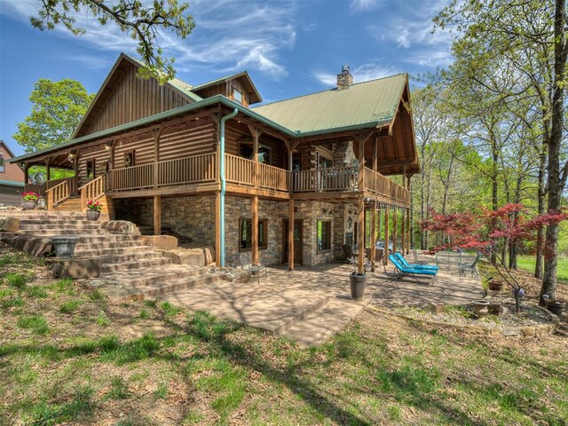2010 Shady Cv, Sulphur, OK 73086 - back of house featuring stone siding, a chimney, metal roof, stairs, and a patio