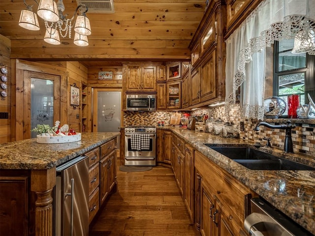 2010 Shady Cv, Sulphur, OK 73086 - kitchen featuring a sink, brown cabinets, backsplash, appliances with stainless steel finishes, and visible vents