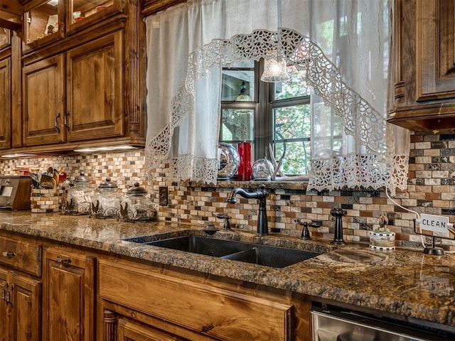 2010 Shady Cv, Sulphur, OK 73086 - kitchen with dishwasher, brown cabinetry, a sink, glass insert cabinets, and tasteful backsplash