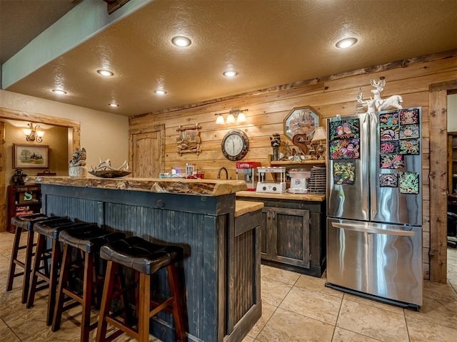 2010 Shady Cv, Sulphur, OK 73086 - bar featuring a textured ceiling, wet bar, freestanding refrigerator, recessed lighting, and wooden walls