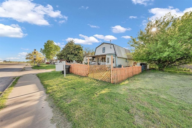 319 S Main St, Pocasset, OK 73079 - view of property exterior with a gambrel roof, fence private yard, and a yard
