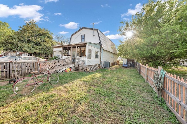 319 S Main St, Pocasset, OK 73079 - back of property featuring a fenced backyard, a yard, central AC, and a deck