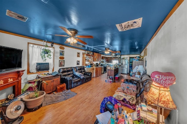 319 S Main St, Pocasset, OK 73079 - living room with wood finished floors and a ceiling fan