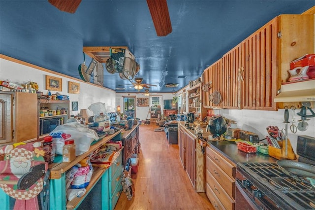 319 S Main St, Pocasset, OK 73079 - kitchen with ceiling fan, stainless steel gas range, and light wood-type flooring