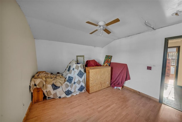 319 S Main St, Pocasset, OK 73079 - bedroom with baseboards, vaulted ceiling, wood finished floors, and a ceiling fan