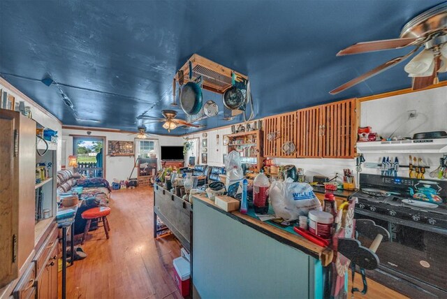 319 S Main St, Pocasset, OK 73079 - kitchen with wood-type flooring, a ceiling fan, and black gas stove