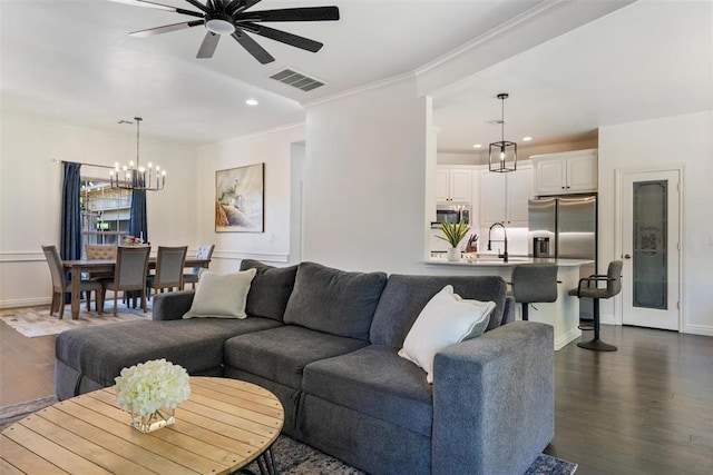 2201 Pine View Ter, Edmond, OK 73003 - living area featuring ceiling fan, crown molding, a chandelier, dark wood finished floors, and recessed lighting