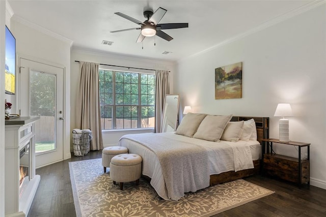 2201 Pine View Ter, Edmond, OK 73003 - bedroom featuring ornamental molding, dark wood-style flooring, a ceiling fan, baseboards, and a glass covered fireplace