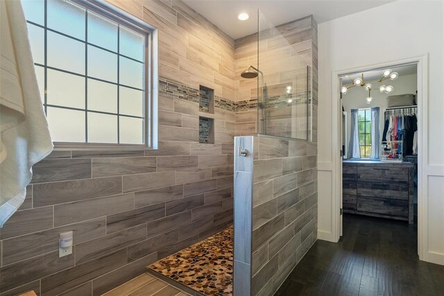 2201 Pine View Ter, Edmond, OK 73003 - full bath featuring walk in shower, hardwood / wood-style floors, a spacious closet, and tile walls