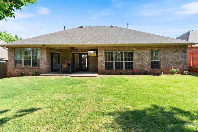 2201 Pine View Ter, Edmond, OK 73003 - back of house with ceiling fan, brick siding, and roof with shingles