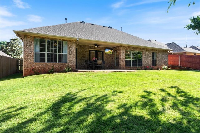 2201 Pine View Ter, Edmond, OK 73003 - back of property featuring ceiling fan, brick siding, a shingled roof, and a patio