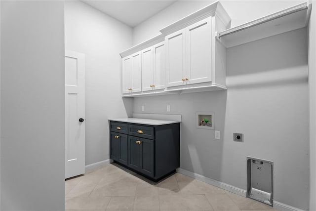 washroom featuring electric dryer hookup, baseboards, light tile patterned floors, washer hookup, and cabinet space