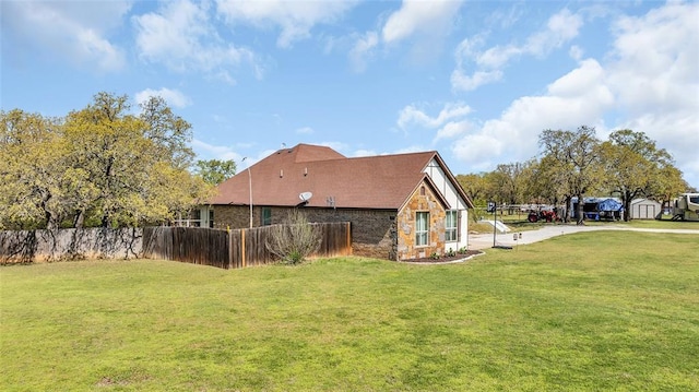 130 Quail Dr, Healdton, OK 73438 - view of property exterior featuring a lawn, fence, and stone siding