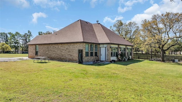130 Quail Dr, Healdton, OK 73438 - back of house with brick siding, a yard, roof with shingles, and fence