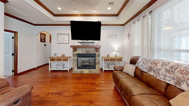 130 Quail Dr, Healdton, OK 73438 - living area with wood-type flooring, arched walkways, visible vents, and a raised ceiling