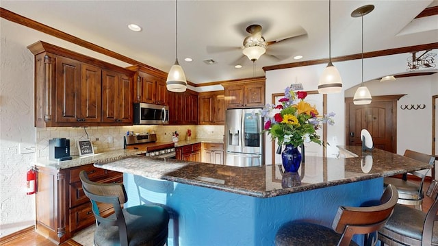 130 Quail Dr, Healdton, OK 73438 - kitchen featuring backsplash, visible vents, a ceiling fan, and stainless steel appliances