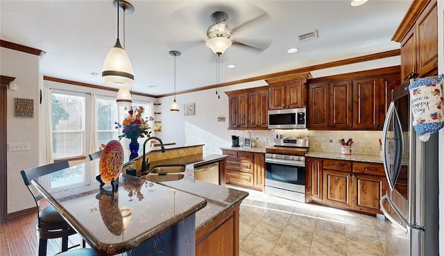 130 Quail Dr, Healdton, OK 73438 - kitchen with a ceiling fan, crown molding, stainless steel appliances, backsplash, and visible vents