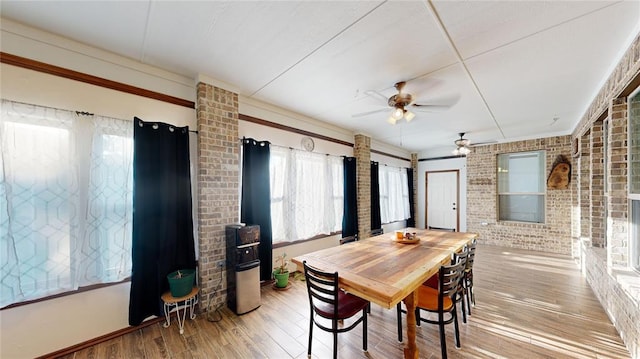 130 Quail Dr, Healdton, OK 73438 - dining room with ceiling fan, wood finished floors, and brick wall
