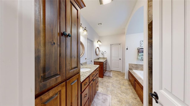 130 Quail Dr, Healdton, OK 73438 - bathroom with two vanities, visible vents, and a sink
