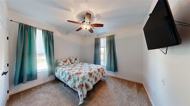 130 Quail Dr, Healdton, OK 73438 - carpeted bedroom featuring baseboards, a ceiling fan, and multiple windows