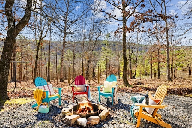 30953 State Hwy Unit 144, Smithville, OK 74957 - view of yard featuring a wooded view and an outdoor fire pit