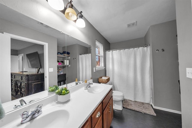7909 Chumley Ln, Oklahoma City, OK 73135 - bathroom featuring a sink, toilet, and visible vents