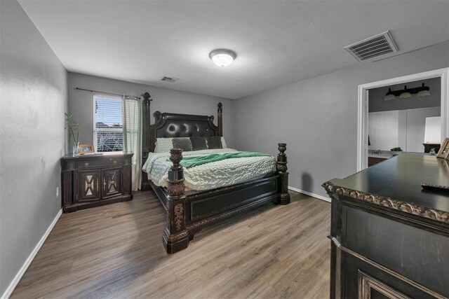 7909 Chumley Ln, Oklahoma City, OK 73135 - bedroom with baseboards, visible vents, and wood finished floors
