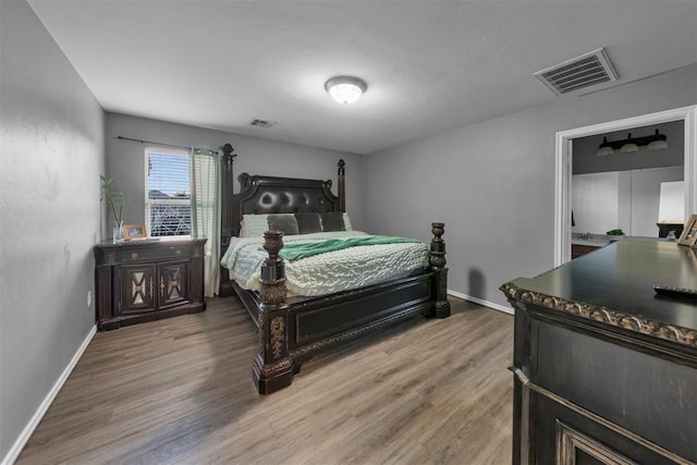 7909 Chumley Ln, Oklahoma City, OK 73135 - bedroom with baseboards, visible vents, and wood finished floors