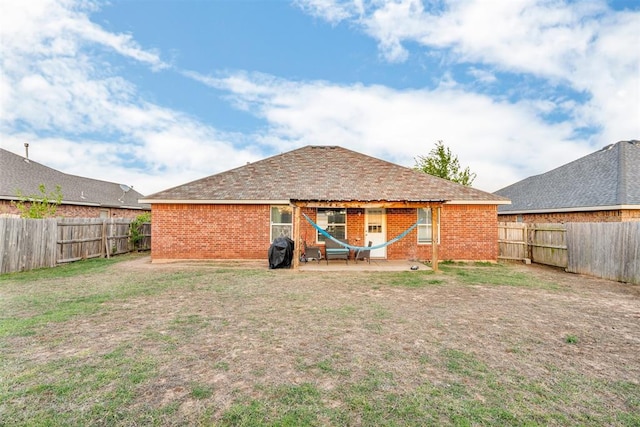 7909 Chumley Ln, Oklahoma City, OK 73135 - rear view of house with a yard, brick siding, a fenced backyard, and a patio area