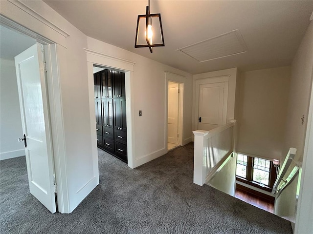 3216 NW 19th St, Oklahoma City, OK 73107 - hallway with an upstairs landing, dark colored carpet, and baseboards